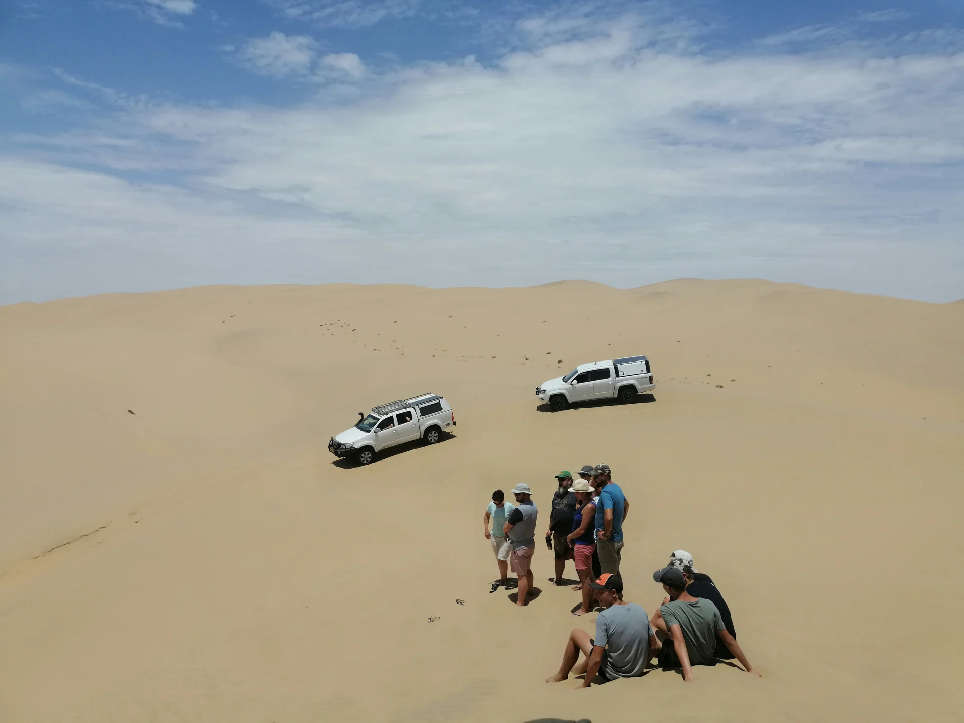 Guests and 4x4 vehicles on Namibia’s dunes